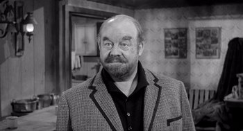 Movie still from “Day of the Outlaw” (1959), directed by André De Toth – An older man with a beard and a jacket on; Close Up shot, High angle