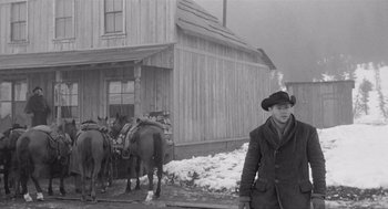 Movie still from “Day of the Outlaw” (1959), directed by André De Toth – A black and white photo of a man and horses; Wide shot, Low angle
