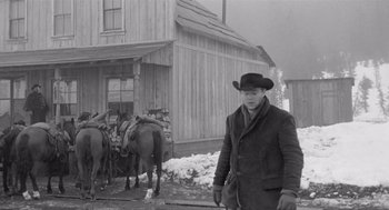 Movie still from “Day of the Outlaw” (1959), directed by André De Toth – A black and white photo of a man in a cowboy hat; Wide shot, Low angle