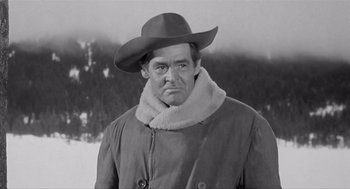 Movie still from “Day of the Outlaw” (1959), directed by André De Toth – A black and white photo of a man wearing a hat; Medium shot, Low angle