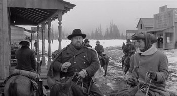 Movie still from “Day of the Outlaw” (1959), directed by André De Toth – An old photo of men on horses in the snow; Medium shot, Low angle
