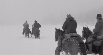 Movie still from “Day of the Outlaw” (1959), directed by André De Toth – A group of people riding horses through the snow; Wide shot, Low angle