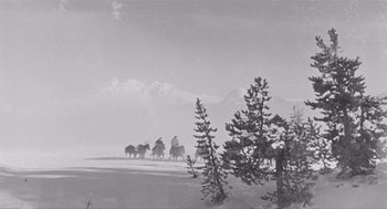 Movie still from “Day of the Outlaw” (1959), directed by André De Toth – A black and white photo of people on horses in the snow; Extreme Wide shot, Low angle