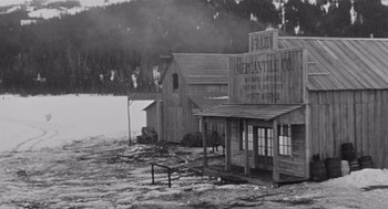 Movie still from “Day of the Outlaw” (1959), directed by André De Toth – An old photo of a store in the middle of a flooded area; Extreme Wide shot, High angle