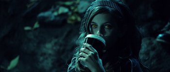 Movie still from “Daybreakers” (2009), directed by Michael Spierig – A woman drinking a cup of coffee in a dark place; Close Up shot, Over the shoulder angle