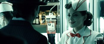 Movie still from “Daybreakers” (2009), directed by Michael Spierig – A woman in a white shirt and a red tie; Close Up shot, Over the shoulder angle