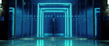 Movie still from “Daybreakers” (2009), directed by Michael Spierig – A man in a suit standing in front of an elevator; Wide shot, Low angle