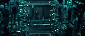 Movie still from “Daybreakers” (2009), directed by Michael Spierig – A man in a suit and tie standing in front of a mirror; Wide shot, Low angle