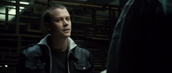 Movie still from “Daybreakers” (2009), directed by Michael Spierig – A man in a black jacket is looking at a man in a black jacket; Close Up shot, Over the shoulder angle