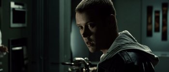 Movie still from “Daybreakers” (2009), directed by Michael Spierig – A person in a dark room; Close Up shot, Over the shoulder angle