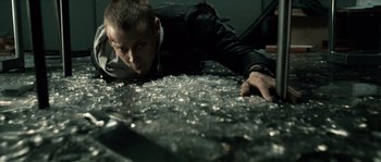 Movie still from “Daybreakers” (2009), directed by Michael Spierig – A man laying on the ground looking at the ground; Medium shot, High angle