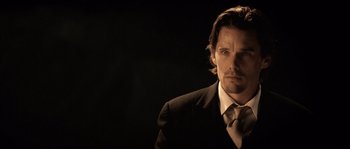 Movie still from “Daybreakers” (2009), directed by Michael Spierig – A man in a suit and a tie; Close Up shot, Over the shoulder angle