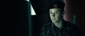 Movie still from “Daybreakers” (2009), directed by Michael Spierig – A man in a military uniform is looking at the camera; Close Up shot, Over the shoulder angle