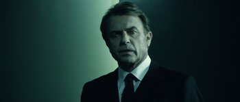 Movie still from “Daybreakers” (2009), directed by Michael Spierig – A person wearing a suit and tie; Close Up shot, Low angle