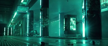 Movie still from “Daybreakers” (2009), directed by Michael Spierig – A view of a room in a building with green lighting; Extreme Wide shot, Low angle