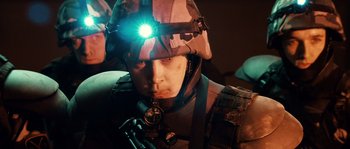 Movie still from “Daybreakers” (2009), directed by Michael Spierig – A man with a helmet on and a flashlight on his head; Close Up shot, Low angle