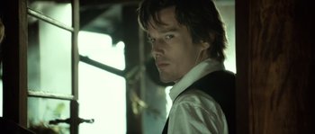 Movie still from “Daybreakers” (2009), directed by Michael Spierig – A person wearing a shirt and tie; Close Up shot, Over the shoulder angle