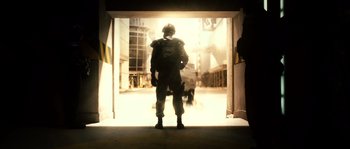 Movie still from “Daybreakers” (2009), directed by Michael Spierig – A soldier standing in front of an open door; Wide shot, Low angle