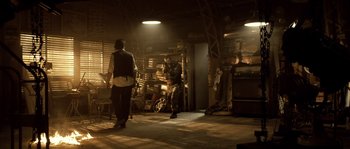 Movie still from “Daybreakers” (2009), directed by Michael Spierig – A man standing next to another man in a room; Wide shot, Over the shoulder angle