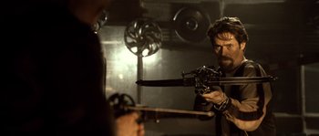 Movie still from “Daybreakers” (2009), directed by Michael Spierig – A man is holding a sword in a room; Medium shot, Over the shoulder angle
