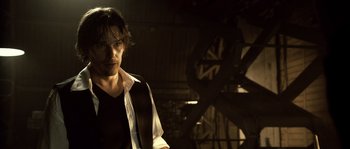 Movie still from “Daybreakers” (2009), directed by Michael Spierig – A man standing next to a large machine; Close Up shot, Low angle