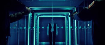 Movie still from “Daybreakers” (2009), directed by Michael Spierig – A woman standing in a room with neon lights; Wide shot, Low angle