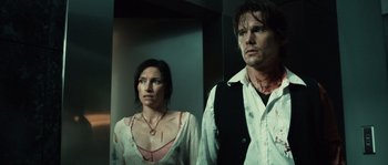 Movie still from “Daybreakers” (2009), directed by Michael Spierig – A man and a woman standing next to each other; Medium shot, Low angle