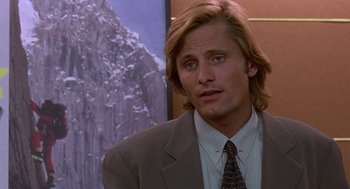 Movie still from “Daylight” (1996), directed by Rob Cohen – A person wearing a suit and tie; Close Up shot, Over the shoulder angle