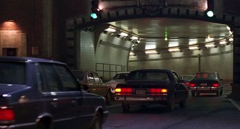 Movie still from “Daylight” (1996), directed by Rob Cohen – Cars driving down a street at night under a bridge; Wide shot, High angle