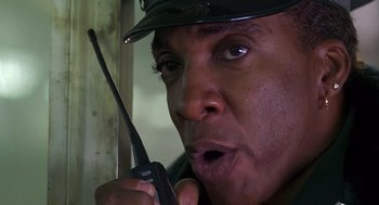 Movie still from “Daylight” (1996), directed by Rob Cohen – A person holding a walkie talkie; Close Up shot, Low angle