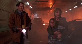 Movie still from “Daylight” (1996), directed by Rob Cohen – A man and a woman are holding a flashlight; Medium shot, Low angle