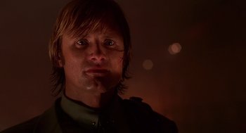 Movie still from “Daylight” (1996), directed by Rob Cohen – A person wearing a green shirt; Close Up shot, Low angle