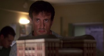 Movie still from “Daylight” (1996), directed by Rob Cohen – A person looking at a computer screen; Close Up shot, Low angle