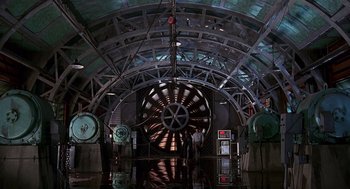Movie still from “Daylight” (1996), directed by Rob Cohen – A room that has a large machine in it; Extreme Wide shot, Low angle