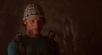 Movie still from “Daylight” (1996), directed by Rob Cohen – A man wearing a hat and holding a flashlight in a dark room; Close Up shot, Low angle