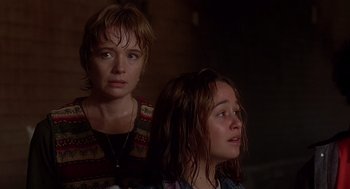 Movie still from “Daylight” (1996), directed by Rob Cohen – Two women looking at the camera in a dark room; Close Up shot, Over the shoulder angle