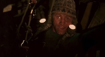 Movie still from “Daylight” (1996), directed by Rob Cohen – A man in a hat is holding a cell phone; Close Up shot, Low angle