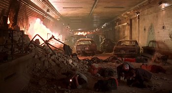 Movie still from “Daylight” (1996), directed by Rob Cohen – A group of people laying down in a building; Wide shot, Low angle