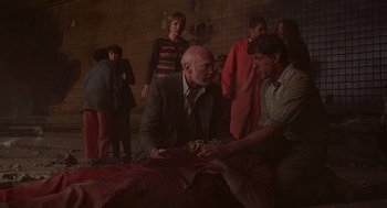 Movie still from “Daylight” (1996), directed by Rob Cohen – An older man and a younger man sitting on a bed; Medium shot, Over the shoulder angle