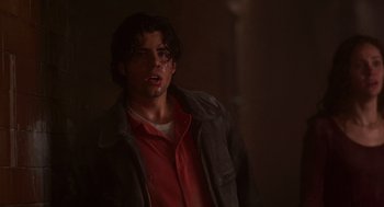 Movie still from “Daylight” (1996), directed by Rob Cohen – A young man in a red shirt and a brown jacket; Close Up shot, Low angle