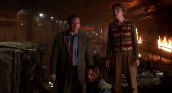 Movie still from “Daylight” (1996), directed by Rob Cohen – A group of people standing in a dark room; Medium shot, Low angle