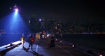 Movie still from “Daylight” (1996), directed by Rob Cohen – A group of people walking along a pier at night; Extreme Wide shot, High angle