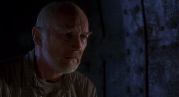 Movie still from “Daylight” (1996), directed by Rob Cohen – An older man with a bald head looking into the distance; Close Up shot, Low angle