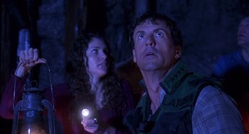 Movie still from “Daylight” (1996), directed by Rob Cohen – A man and a woman looking up at the sky with a flashlight; Close Up shot, Low angle
