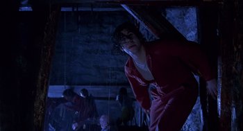 Movie still from “Daylight” (1996), directed by Rob Cohen – A man in a red jacket standing in a dark room; Medium shot, Low angle
