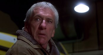 Movie still from “Daylight” (1996), directed by Rob Cohen – An older man with grey hair looking at the camera; Close Up shot, Low angle