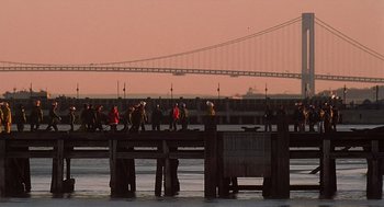 Movie still from “Daylight” (1996), directed by Rob Cohen – A group of people walking across a bridge; Extreme Wide shot, High angle