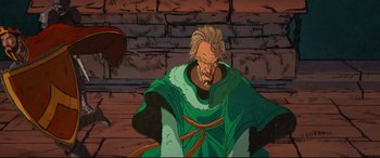 Movie still from “The Kid Who Would Be King” (2019), directed by Joe Cornish – An old man with a beard wearing a green robe; Medium shot, Low angle