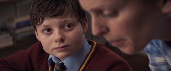 Movie still from “The Kid Who Would Be King” (2019), directed by Joe Cornish – A young boy and a man looking at each other; Close Up shot, Over the shoulder angle