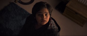 Movie still from “The Kid Who Would Be King” (2019), directed by Joe Cornish – A young boy is looking up at the camera; Close Up shot, High angle